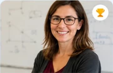 Jessica T., in glasses, in front of a whiteboard of diagrams