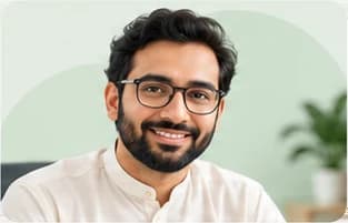 Usman Sir, in glasses, smiling in a bright room