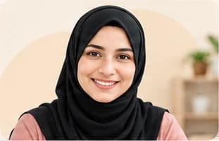 Zainab Ma'am, in a black hijab, smiling at the camera